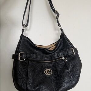 Black pebble back with silver accents and lots of compartments adjustable straps